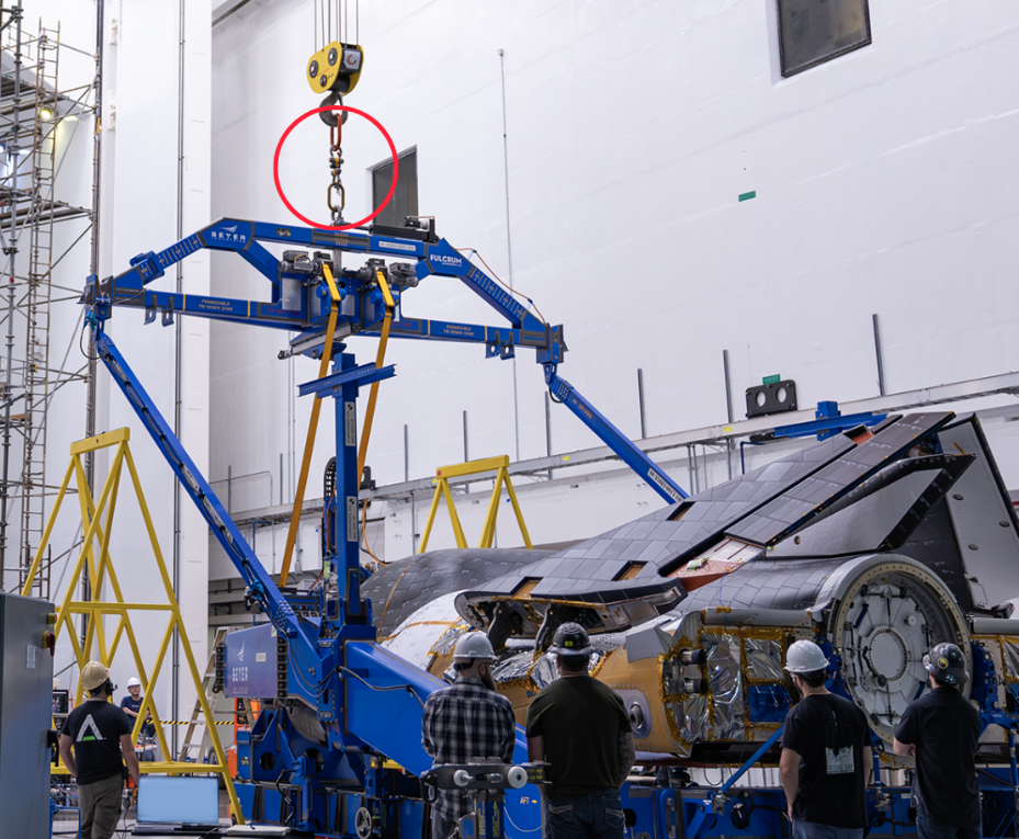 Worker watch the Tenacity spaceplane as it’s hoisted using a Ron Crane Scale Worker watch the Tenacity spaceplane as it’s hoisted using a Ron Crane Scale